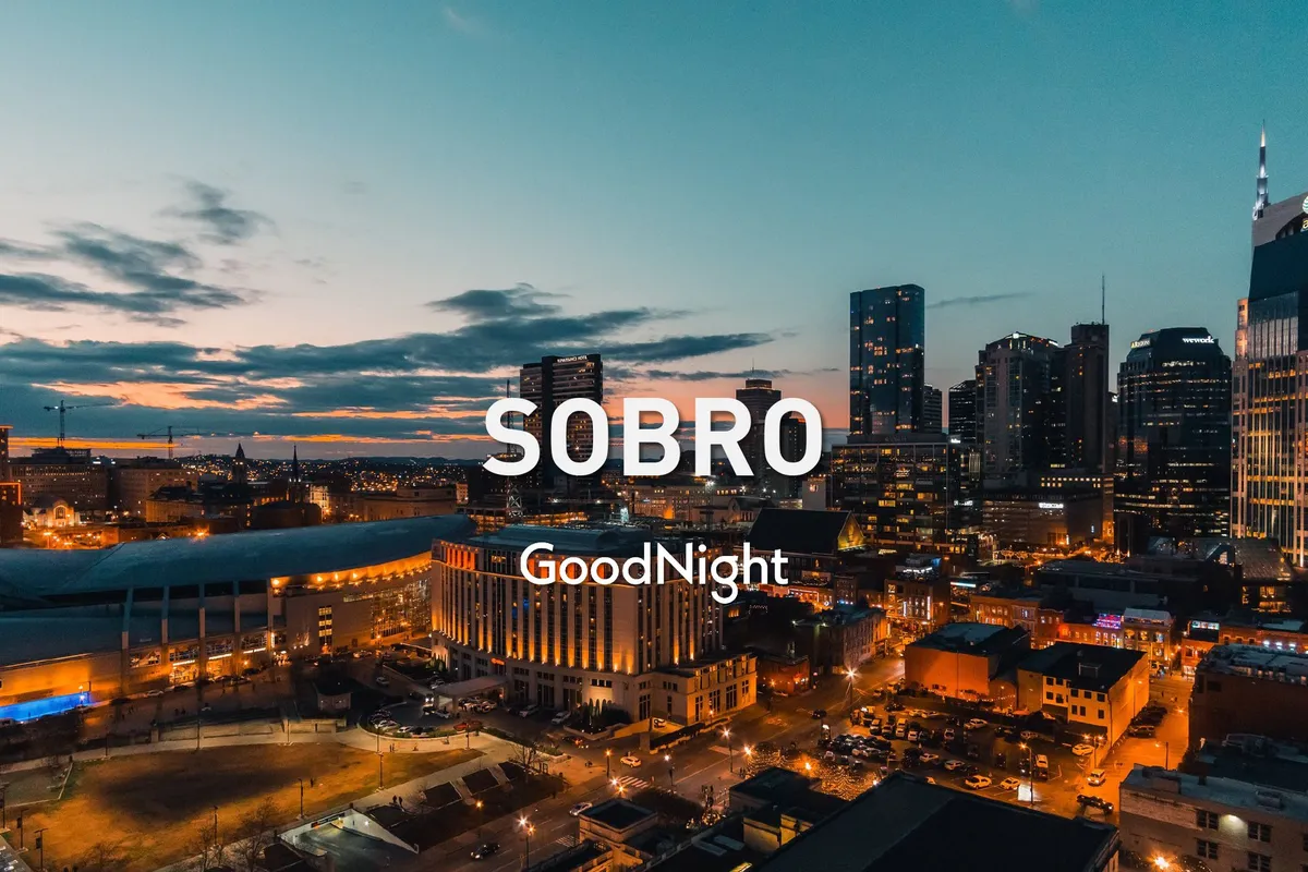 A panoramic view of Nashville’s illuminated skyline at sunset, capturing the city’s dynamic energy and welcoming atmosphere. The glowing buildings and colorful sky evoke the transition from daytime adventures to evening exploration across the city’s hotspots.
