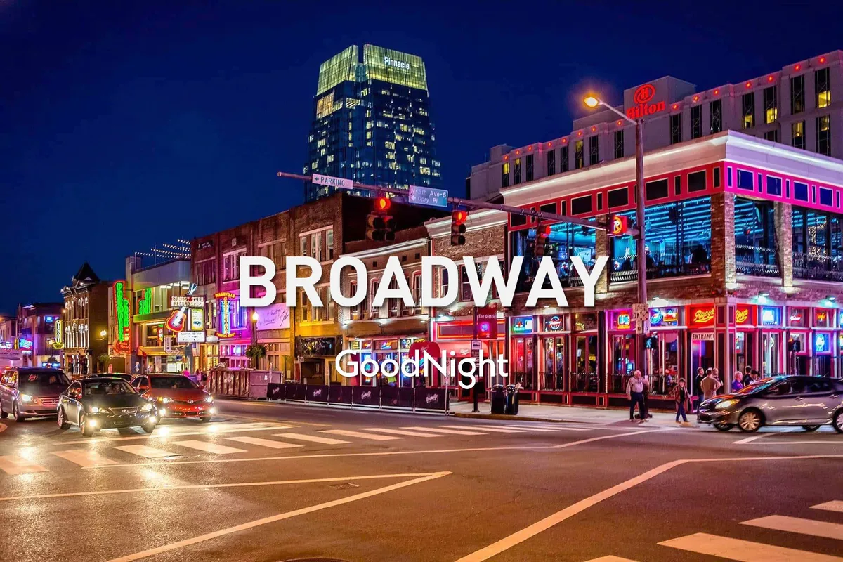 This energetic street scene is illuminated by vibrant neon signs, bustling with people enjoying local nightlife, dining at restaurants, and exploring shops. The tall buildings and colorful lighting evoke the iconic Broadway atmosphere, known for live music and festive events.