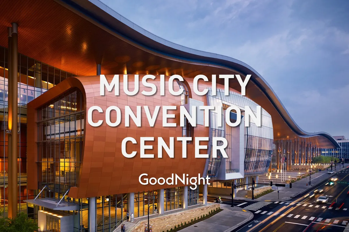 An impressive exterior shot of the Music City Center, with its distinctive curved roof and glass facade welcoming visitors. The scene radiates activity and modernity, symbolizing Nashville’s role as a major convention and business destination.